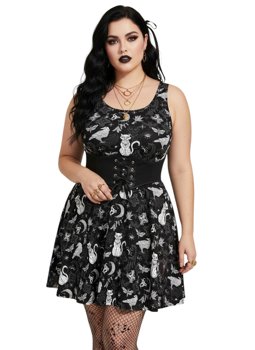 Plus size woman wearing a Whimsigoth fit and flare dress with witchy cat and celestial moon prints.
