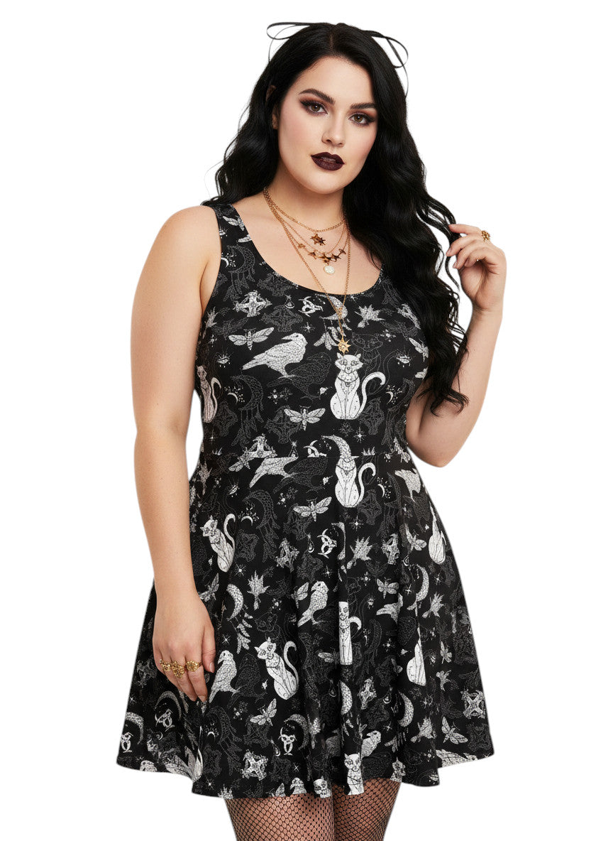 Plus size woman wearing a Whimsigoth fit and flare dress with witchy cat and celestial moon prints.