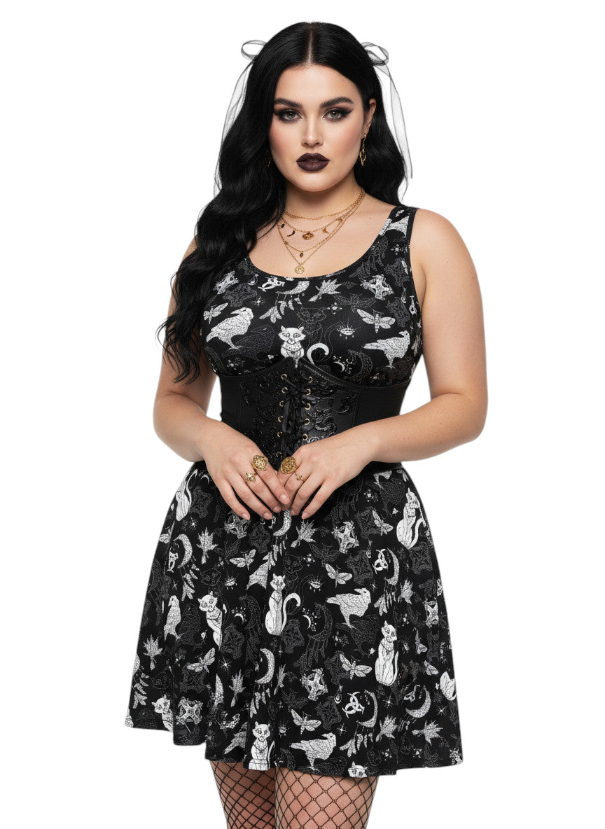Plus size woman wearing a Whimsigoth fit and flare dress with witchy cat and celestial moon prints.
