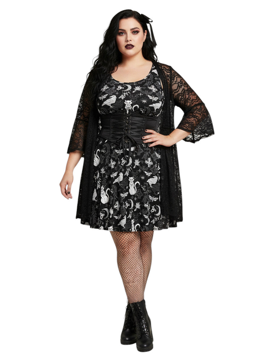 Woman wearing a Whimsigoth fit and flare dress with witchy cat and celestial moon prints.