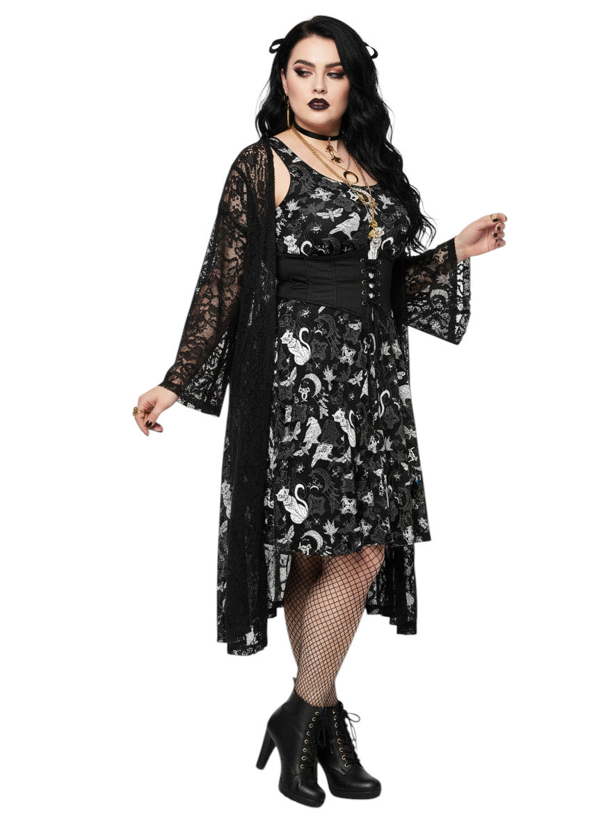 Woman wearing a Whimsigoth fit and flare dress with witchy cat and celestial moon prints.
