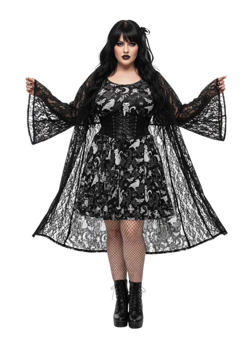 Plus size woman wearing a Whimsigoth fit and flare dress with witchy cat and celestial moon prints.