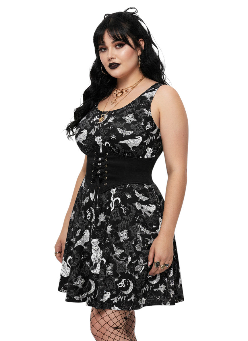 Plus size woman wearing a Whimsigoth fit and flare dress with witchy cat and celestial moon prints.
