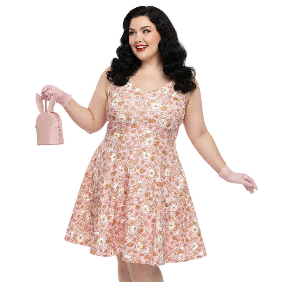 Plus size woman wearing a 1950s style pink Easter bunny print swing dress with a fit and flare silhouette.