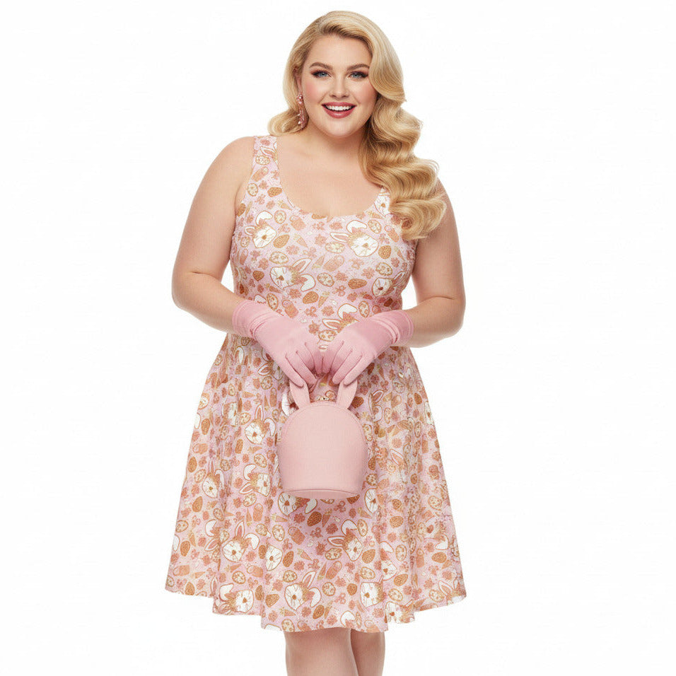 Plus size woman wearing a 1950s style pink Easter bunny print swing dress with a fit and flare silhouette.