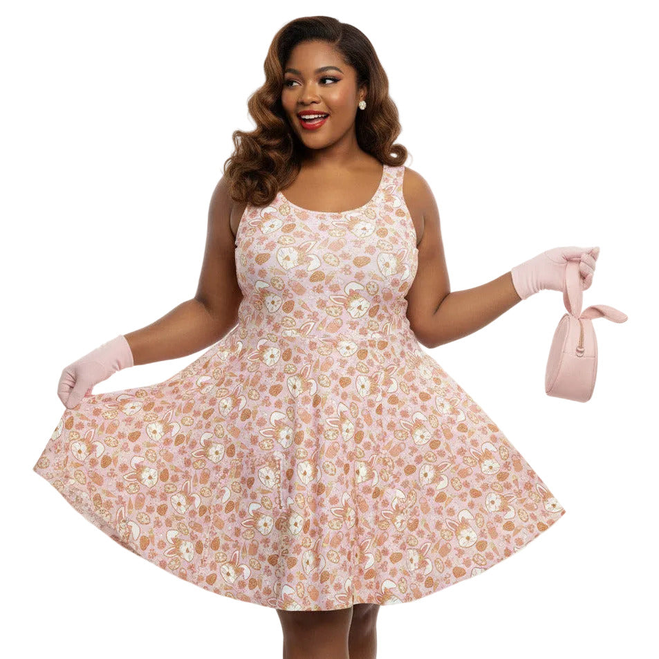 Plus size woman wearing a 1950s style pink Easter bunny print swing dress with a fit and flare silhouette.