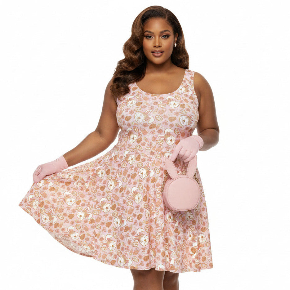 Plus size woman wearing a 1950s style pink Easter bunny print swing dress with a fit and flare silhouette.