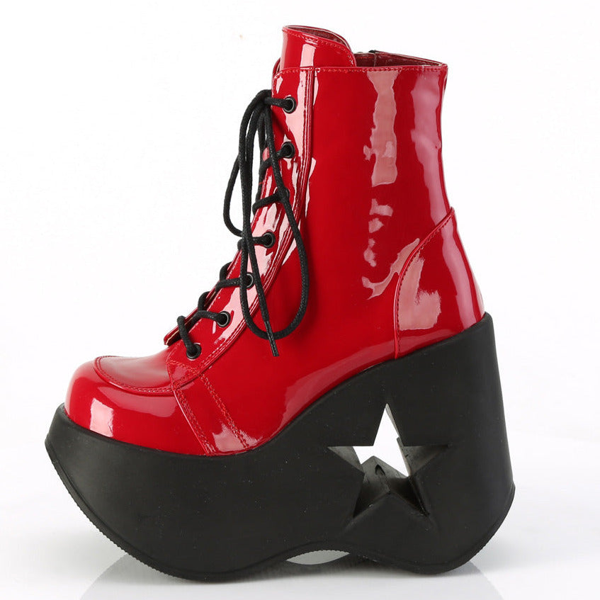 Red faux patent leather platform wedge ankle boots with 5 inch star cutout heel and black laces.