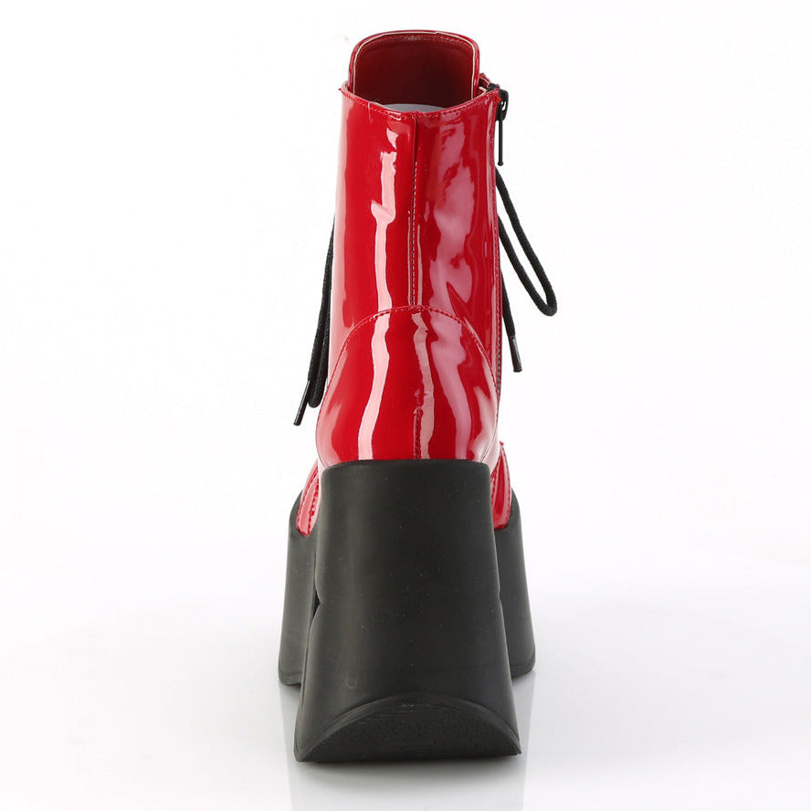 Red faux patent leather platform wedge ankle boots with 5 inch star cutout heel and black laces.