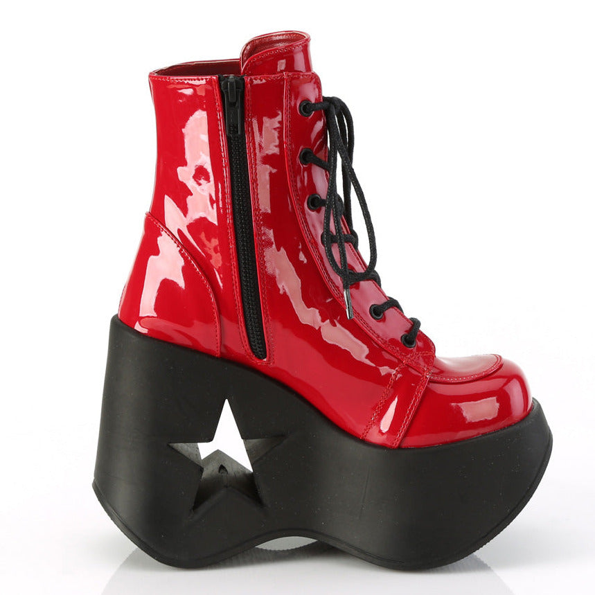 Red faux patent leather platform wedge ankle boots with 5 inch star cutout heel and black laces.