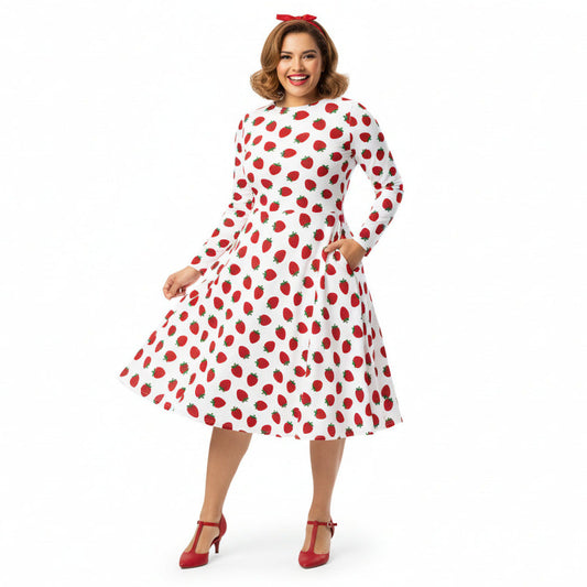 Woman wearing white and red strawberry print long sleeve dress