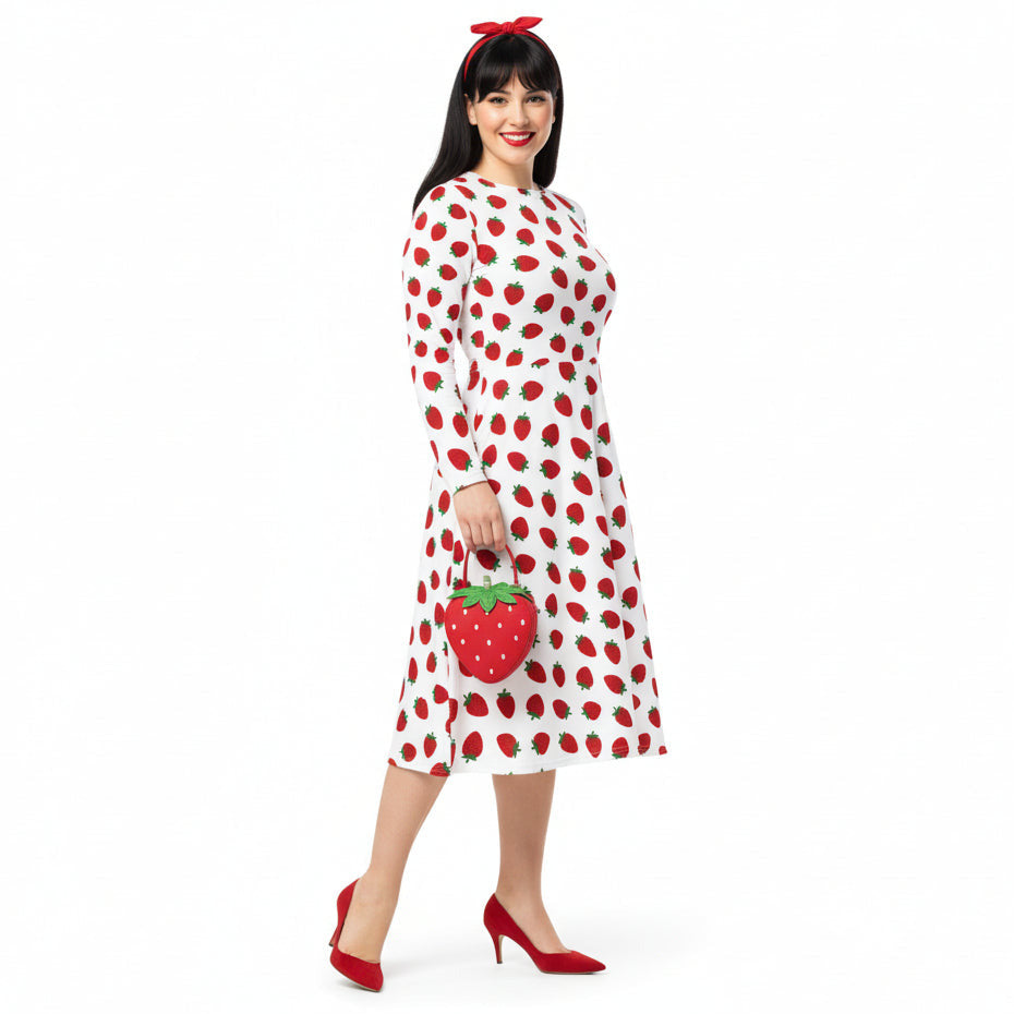 Woman wearing white and red strawberry print long sleeve dress on white background
