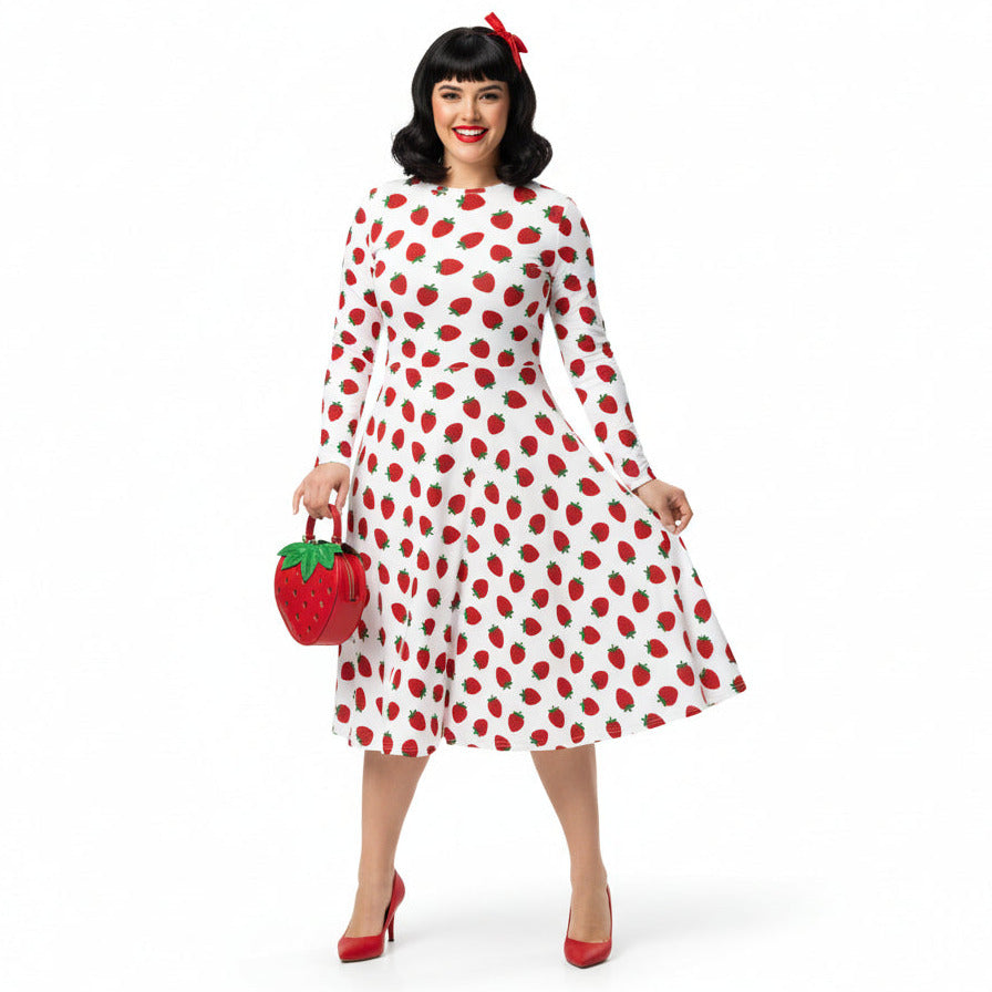 Woman wearing white and red strawberry print long sleeve dress on white background