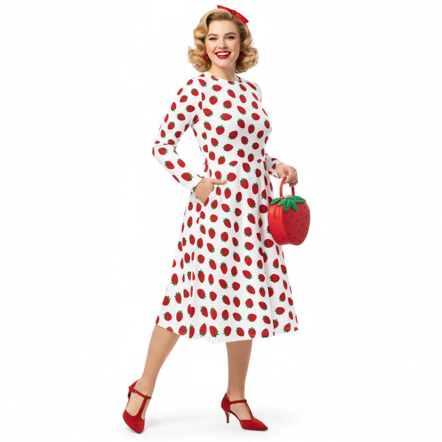 Woman wearing white and red strawberry print long sleeve dress on white background
