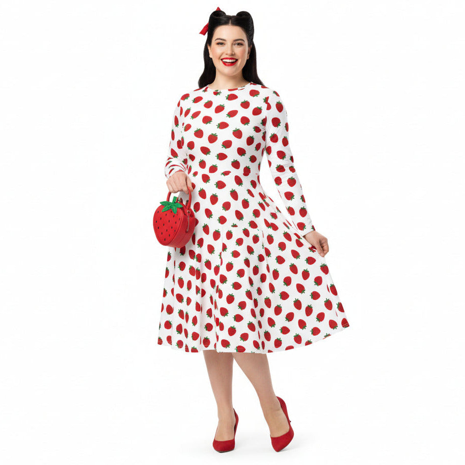 Woman wearing white and red strawberry print long sleeve dress on white background