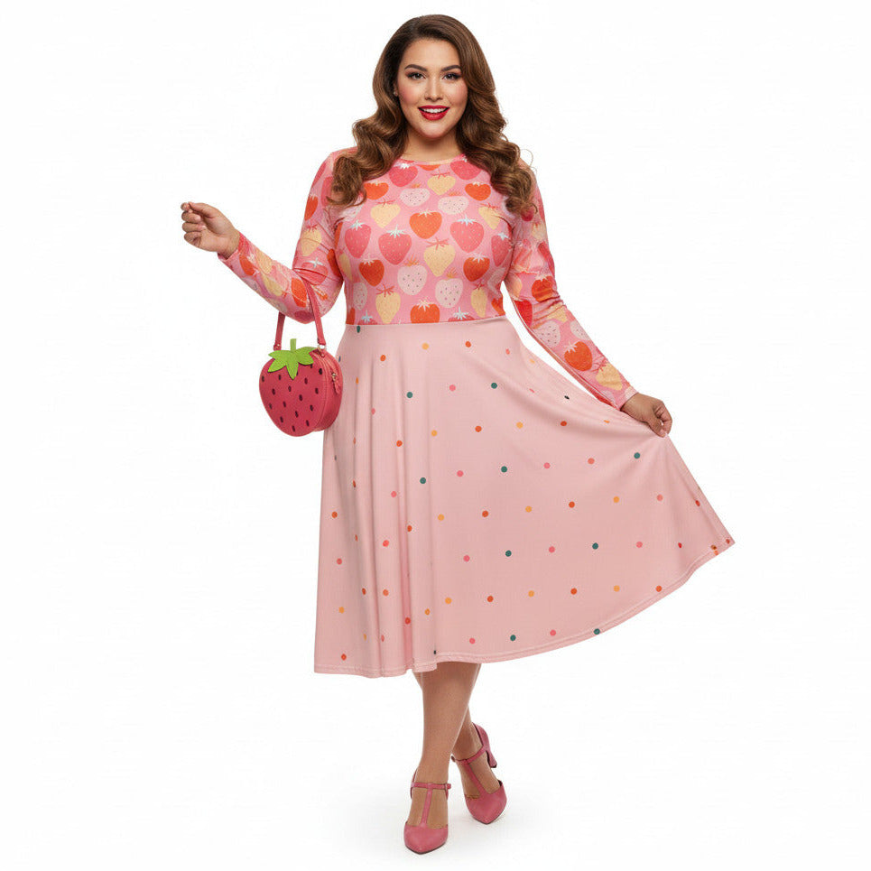 Plus size woman wearing pink and red strawberry print long sleeve pin up dress with pockets