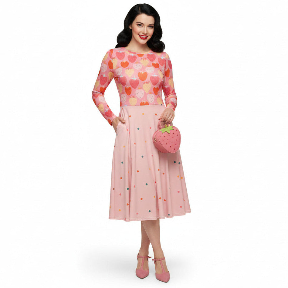 woman wearing pink and red strawberry print long sleeve pin up dress with pockets