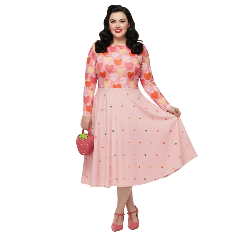 Plus size woman wearing pink and red strawberry print long sleeve pin up dress with pockets