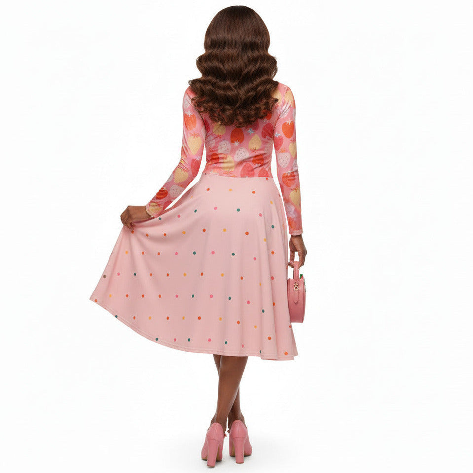 woman wearing pink and red strawberry print long sleeve pin up dress with pockets