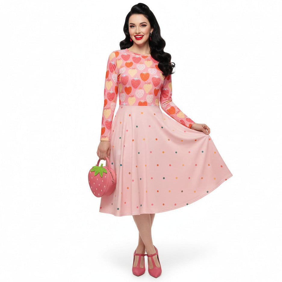 woman wearing pink and red strawberry print long sleeve pin up dress with pockets