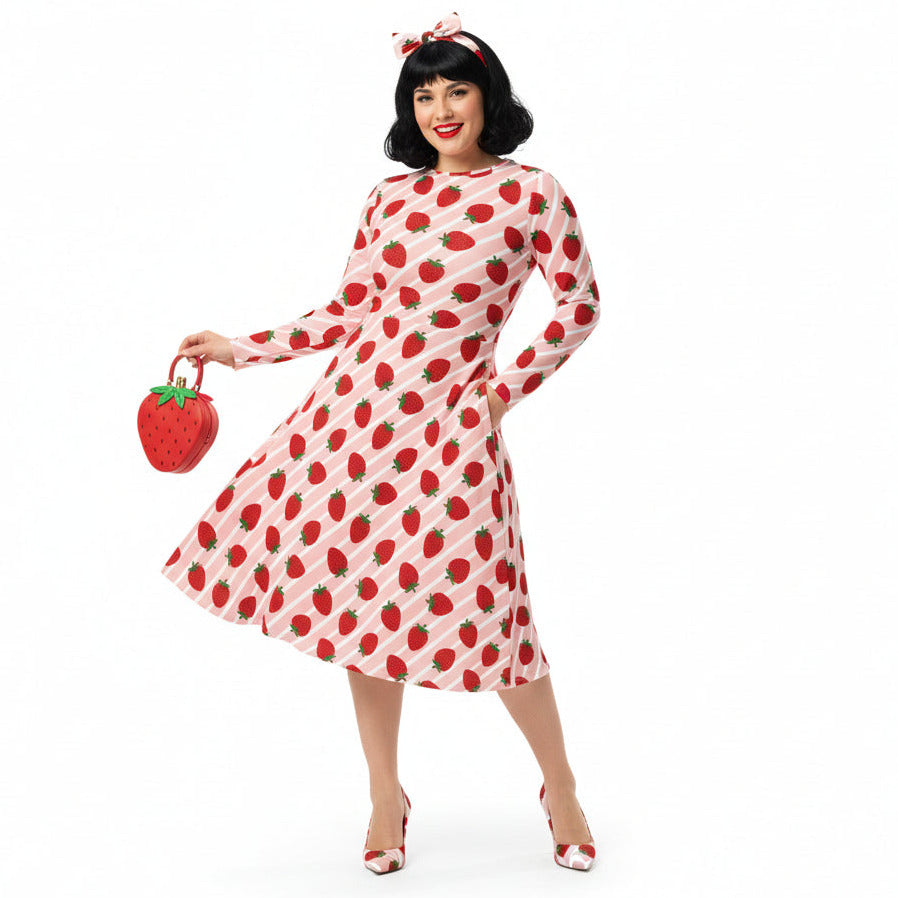 Woman wearing Strawberry print longsleeve dress with pockets on white background