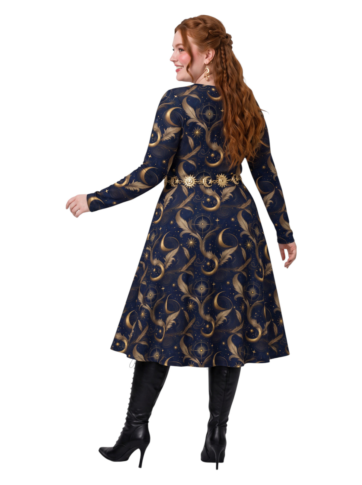 A woman modeling a long-sleeve A-line dress with a celestial print, shown from the back. The dress is navy blue with gold crescent moons and stars, featuring a gold sunburst belt at the waist.