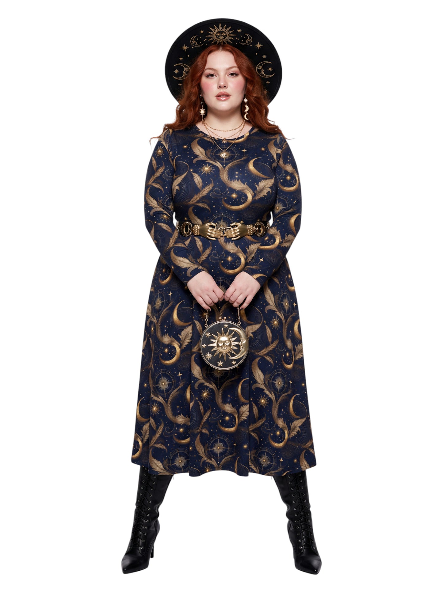 A model wearing a long-sleeved navy blue midi dress with a gold celestial print of crescent moons and stars, accessorized with a gold belt, a matching round handbag, and a wide-brimmed black hat with gold detailing, set against a plain white background.