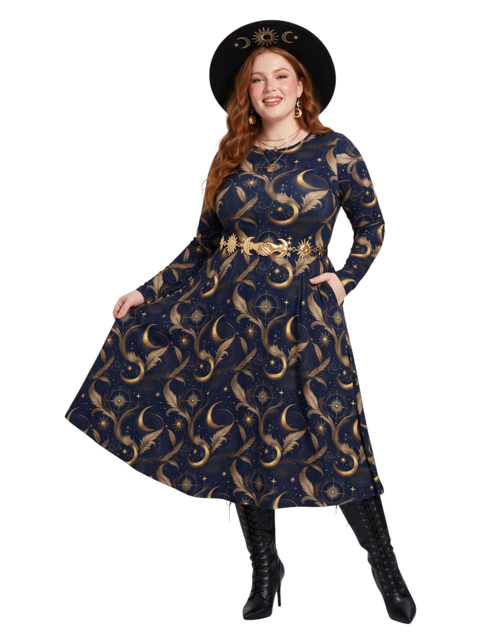 A woman modeling a long-sleeve midi dress with a celestial print of gold moons and stars on a dark navy blue background. She is wearing a matching black wide-brim hat with gold celestial details, a gold belt, and black heeled boots against a solid white background.