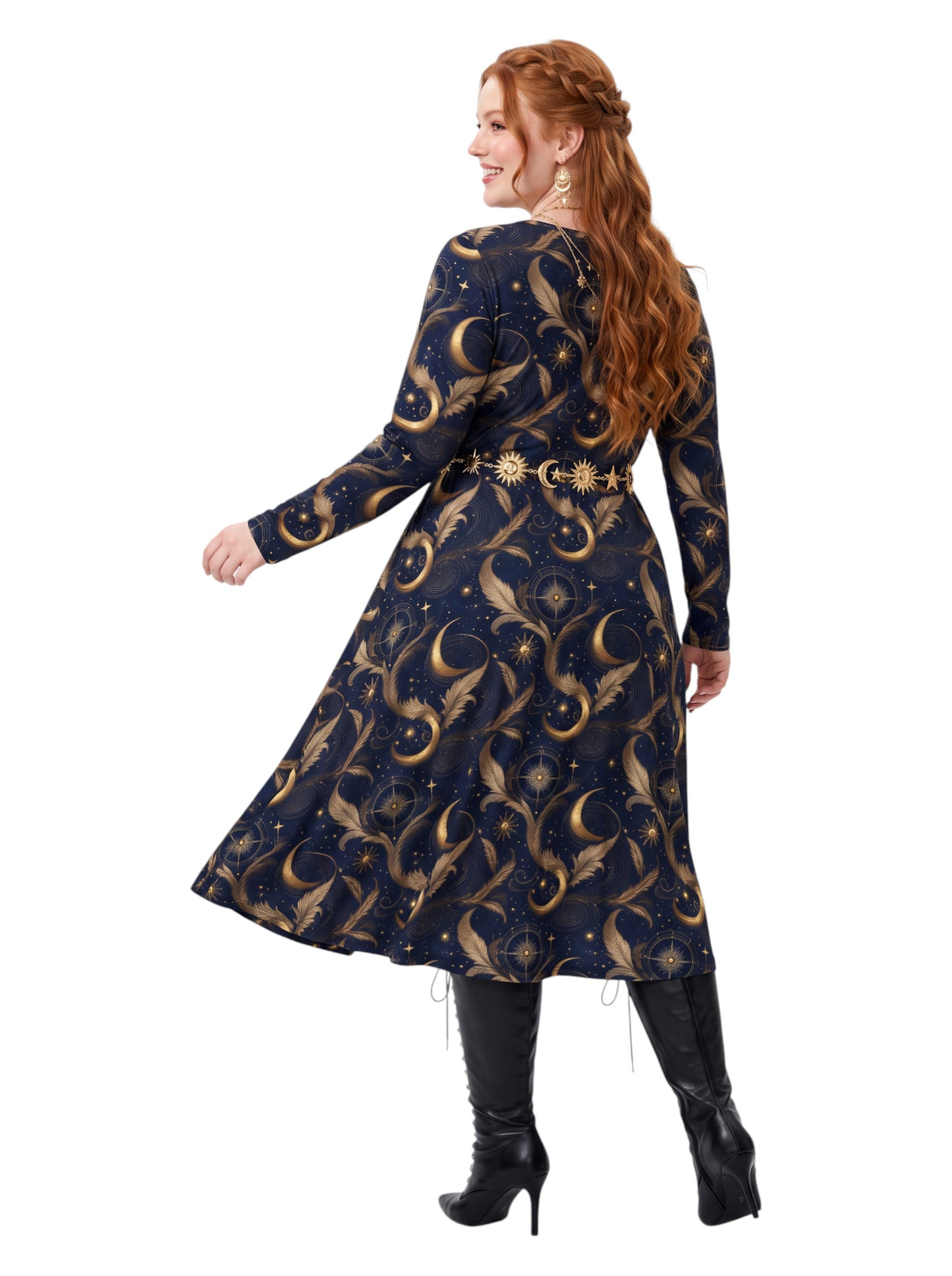 A woman modeling a long-sleeve A-line dress with a celestial print in navy blue and gold, paired with black knee-high boots against a solid white background.