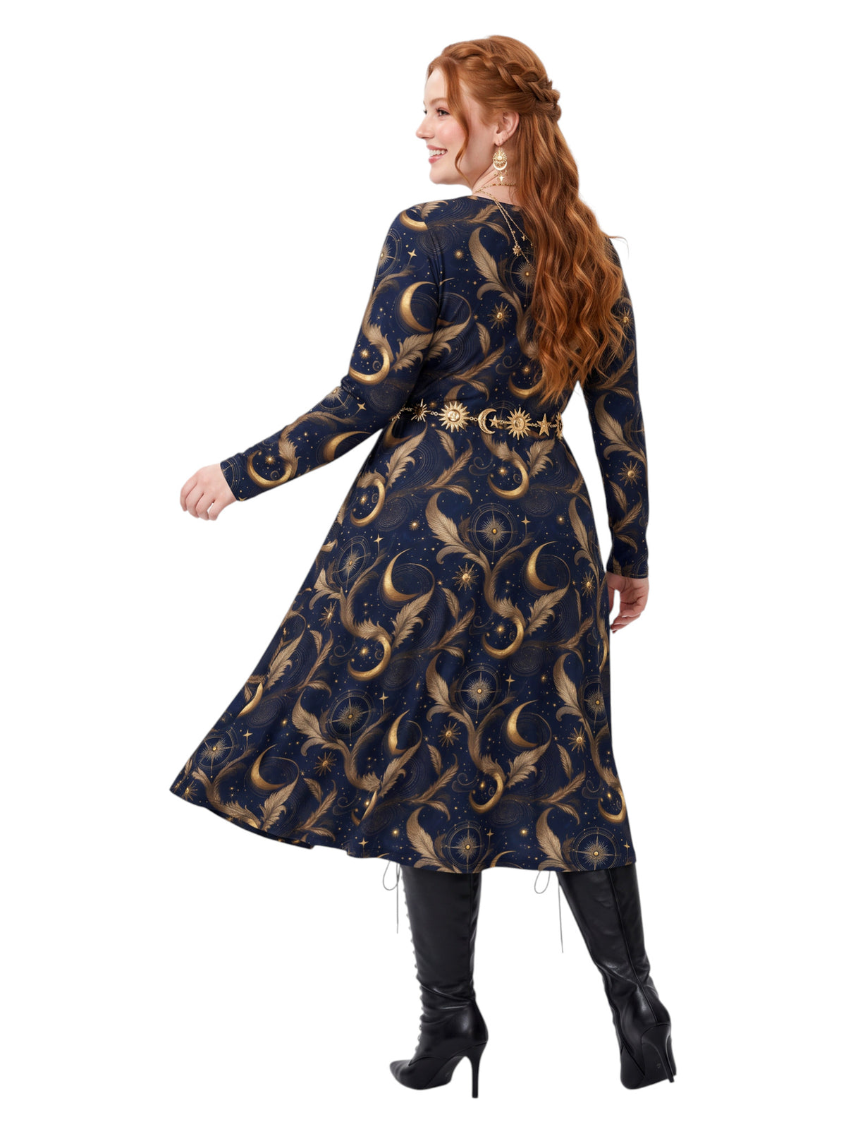 A woman modeling a long-sleeve A-line dress with a celestial print in navy blue and gold, paired with black knee-high boots against a solid white background.