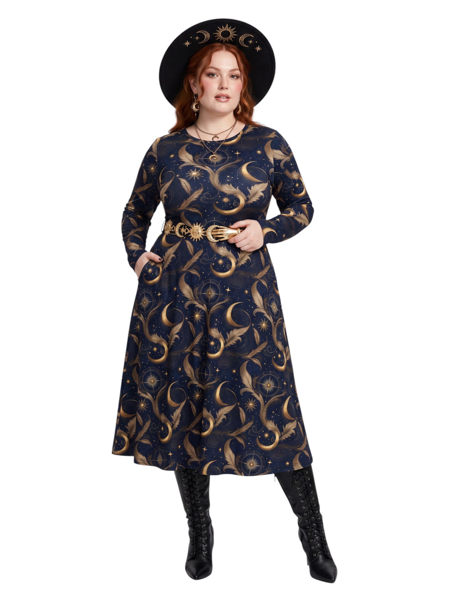 A woman modeling a long-sleeve navy midi dress with a gold celestial print of crescent moons, stars, and birds, styled with a gold belt, a black witch hat, and black boots against a white background.