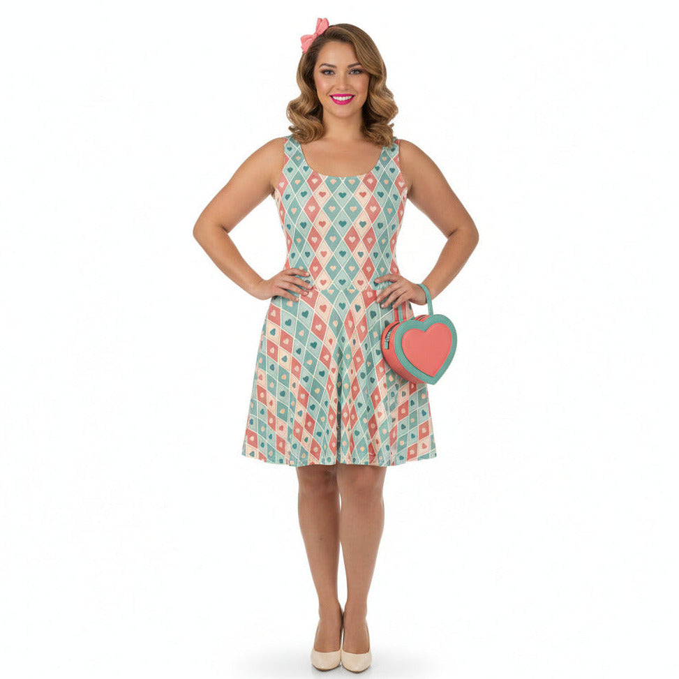 Woman wearing a patterned dress holding a heart-shaped clutch on a white background