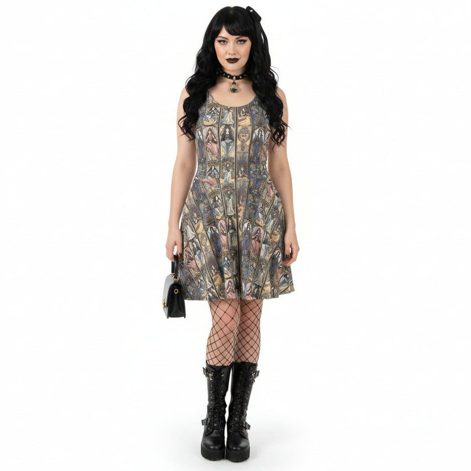 Woman wearing a patterned dress with fishnet stockings and black boots on a white background