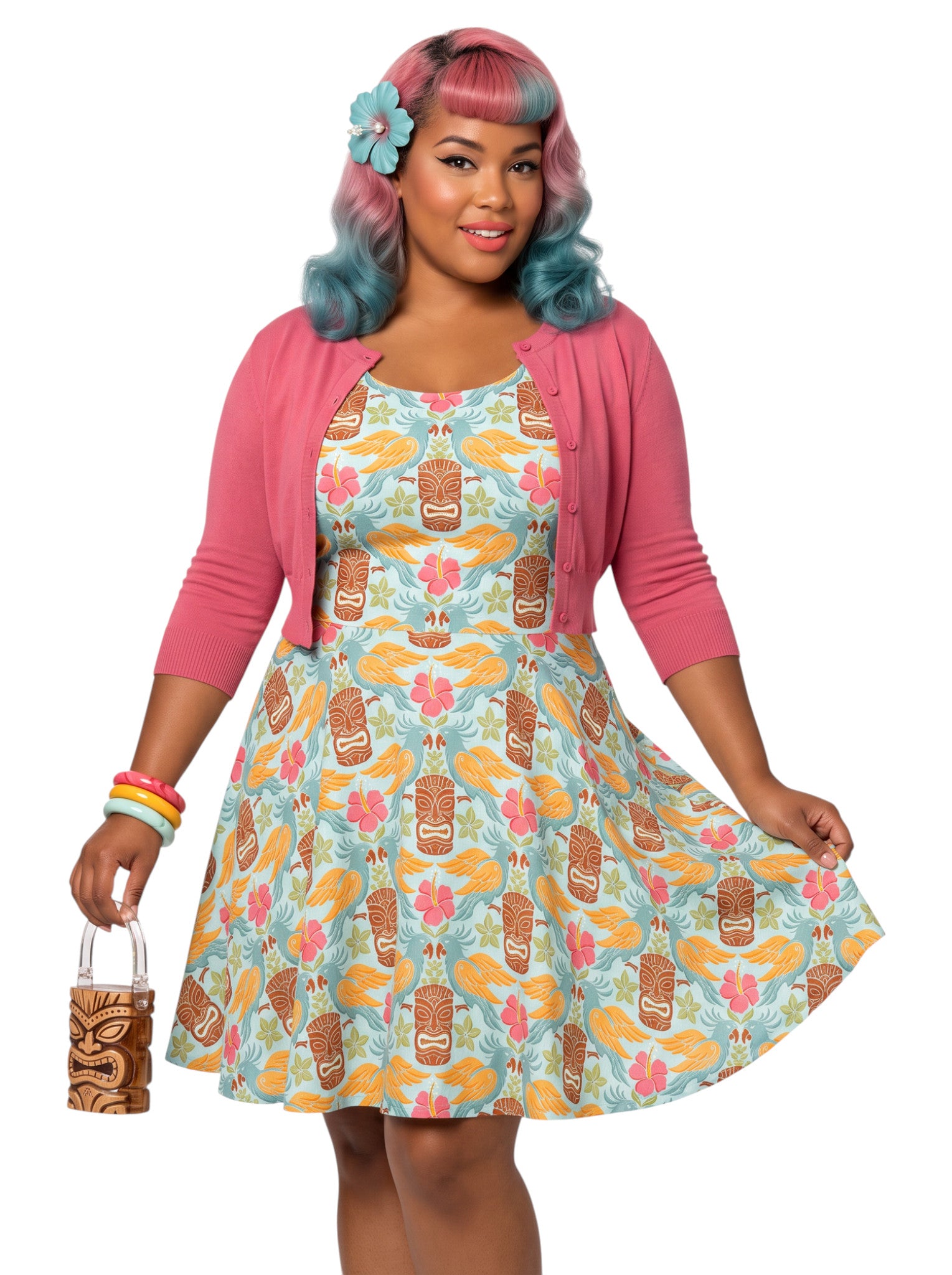 Plus-size woman in a tropical light blue Tiki mask and hibiscus flower print fit and flare swing dress highlighting a comfortable, inclusive curvy fit.