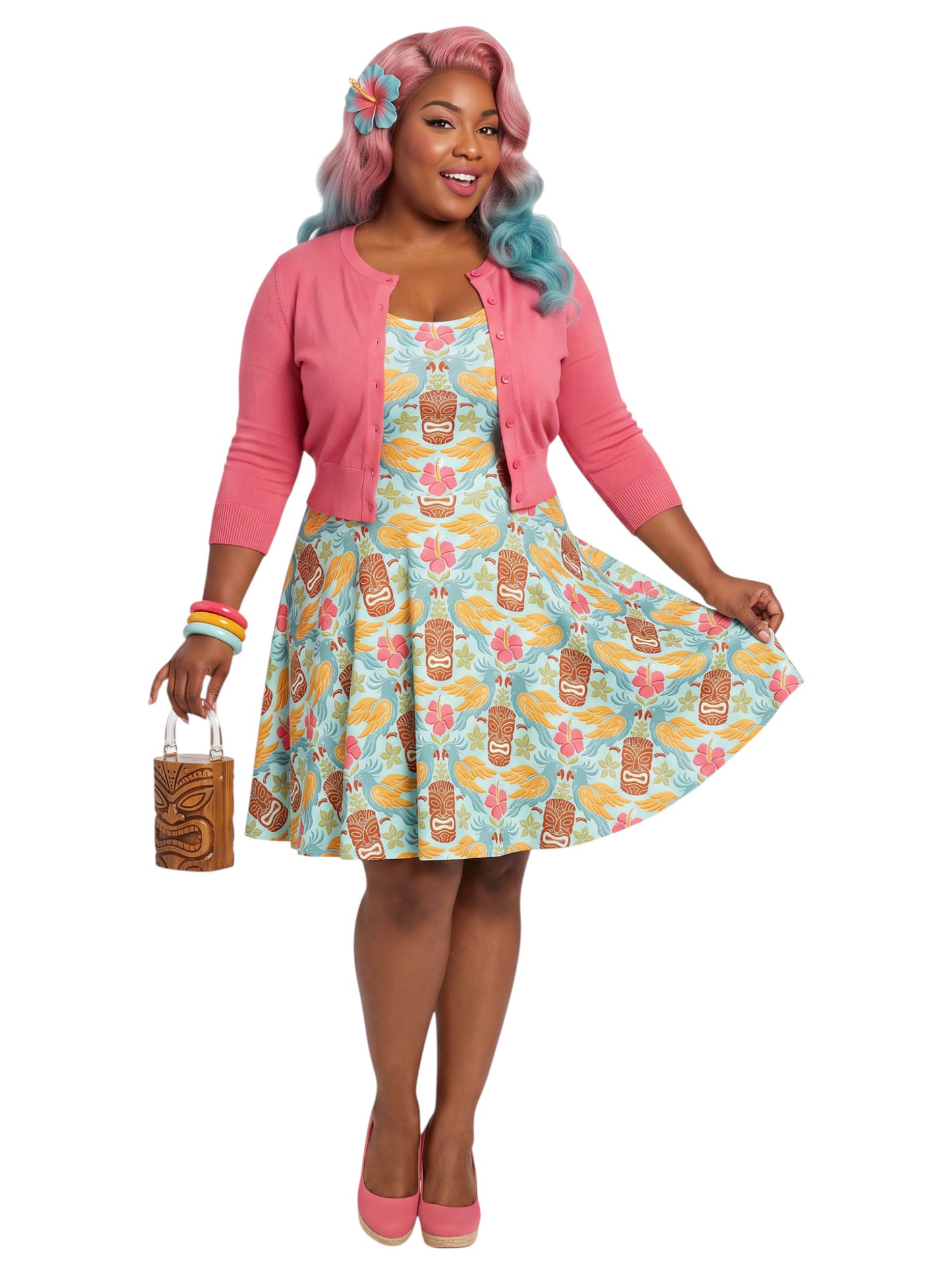 Plus-size woman in a tropical light blue Tiki mask and hibiscus flower print fit and flare swing dress highlighting a comfortable, inclusive curvy fit.