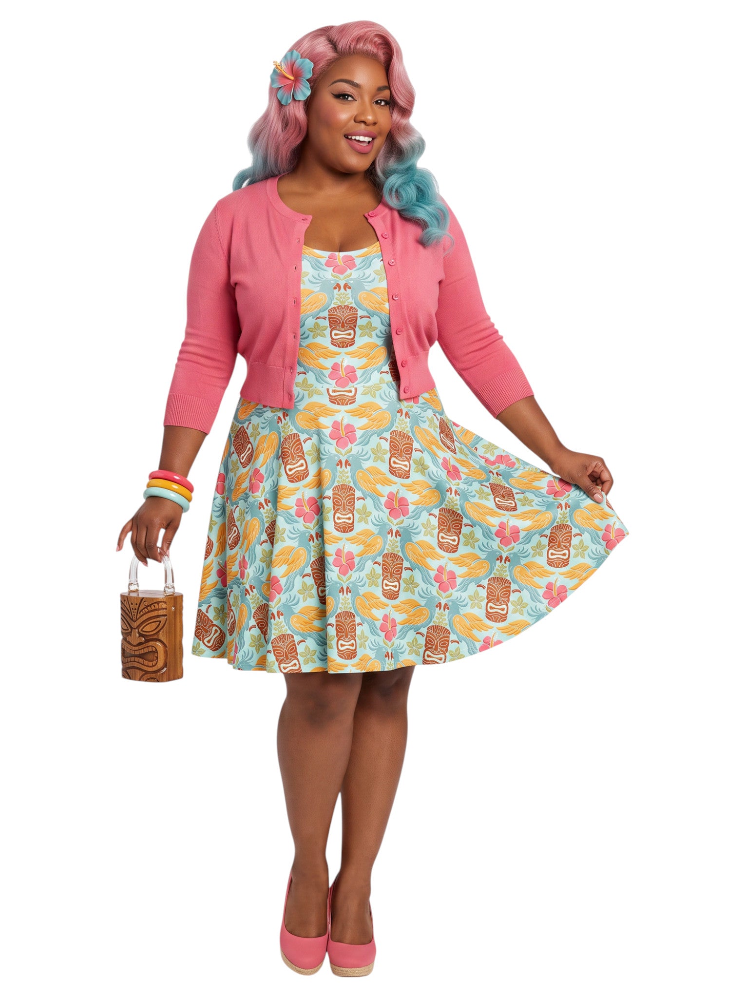 Plus-size woman in a tropical light blue Tiki mask and hibiscus flower print fit and flare swing dress highlighting a comfortable, inclusive curvy fit.