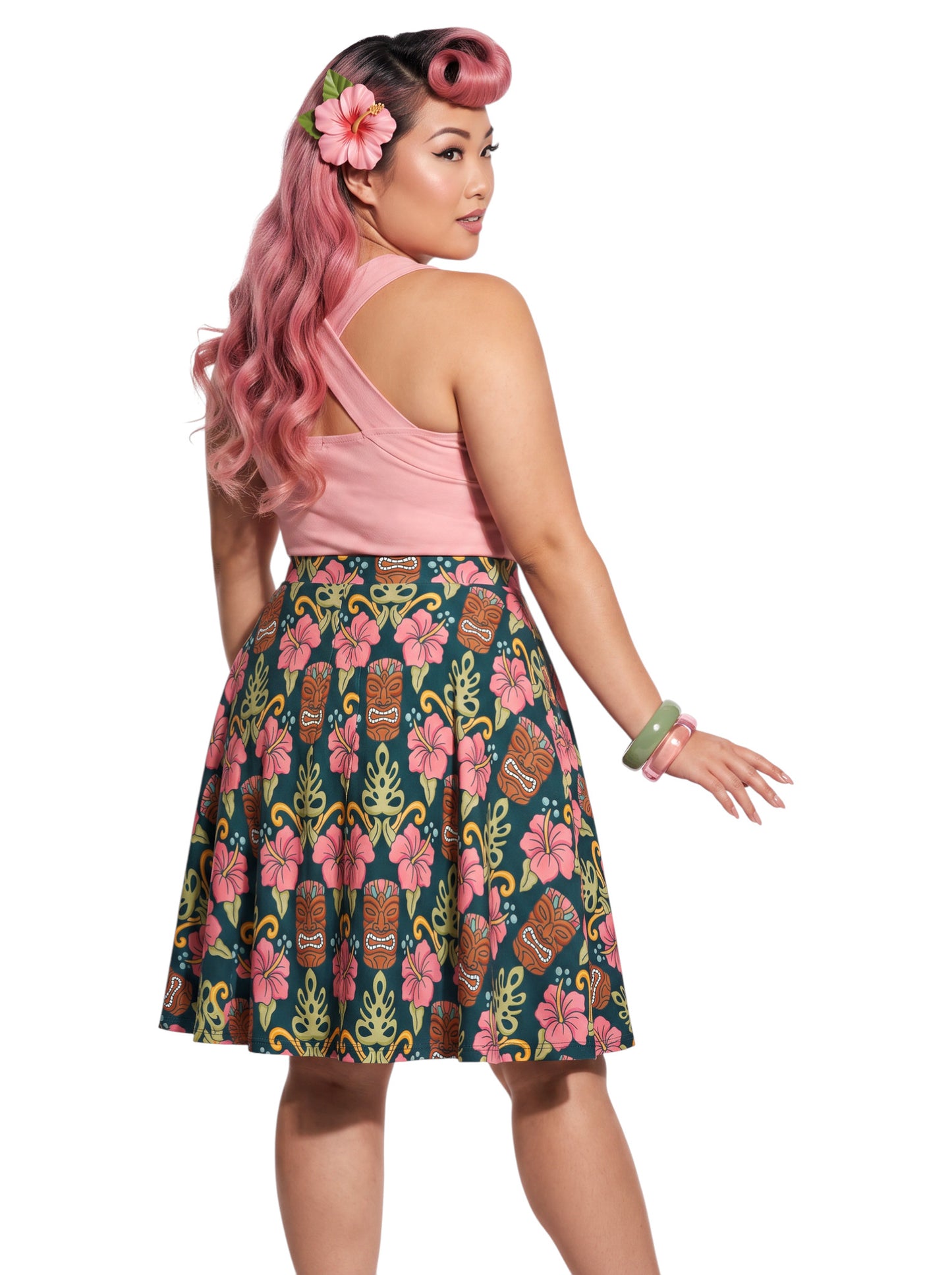 Plus-size woman wearing high-waisted tiki mask and hibiscus flower print pinup swing skirt with pink halter top.