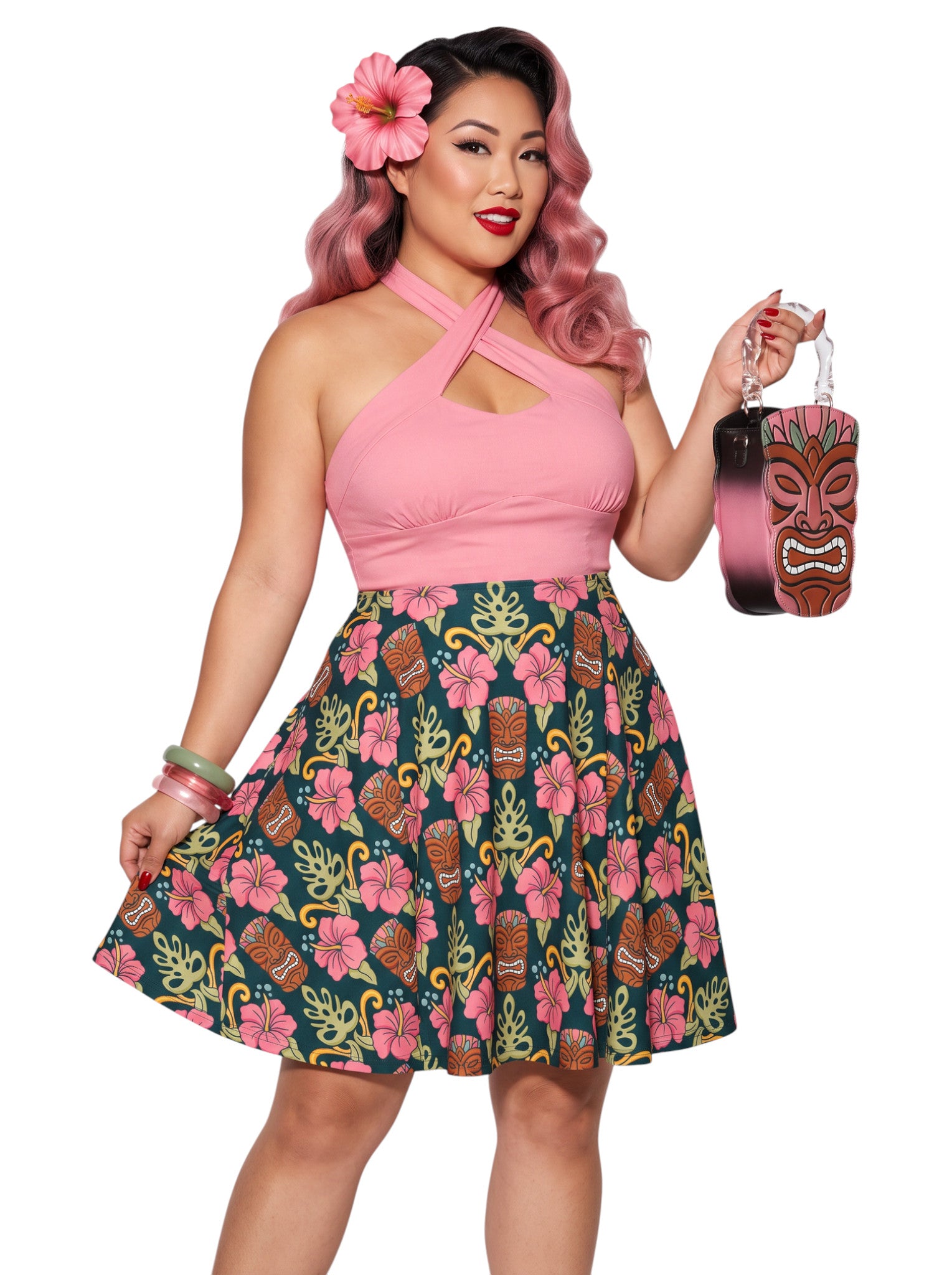 Plus-size woman wearing high-waisted tiki mask and hibiscus flower print pinup swing skirt with pink halter top.