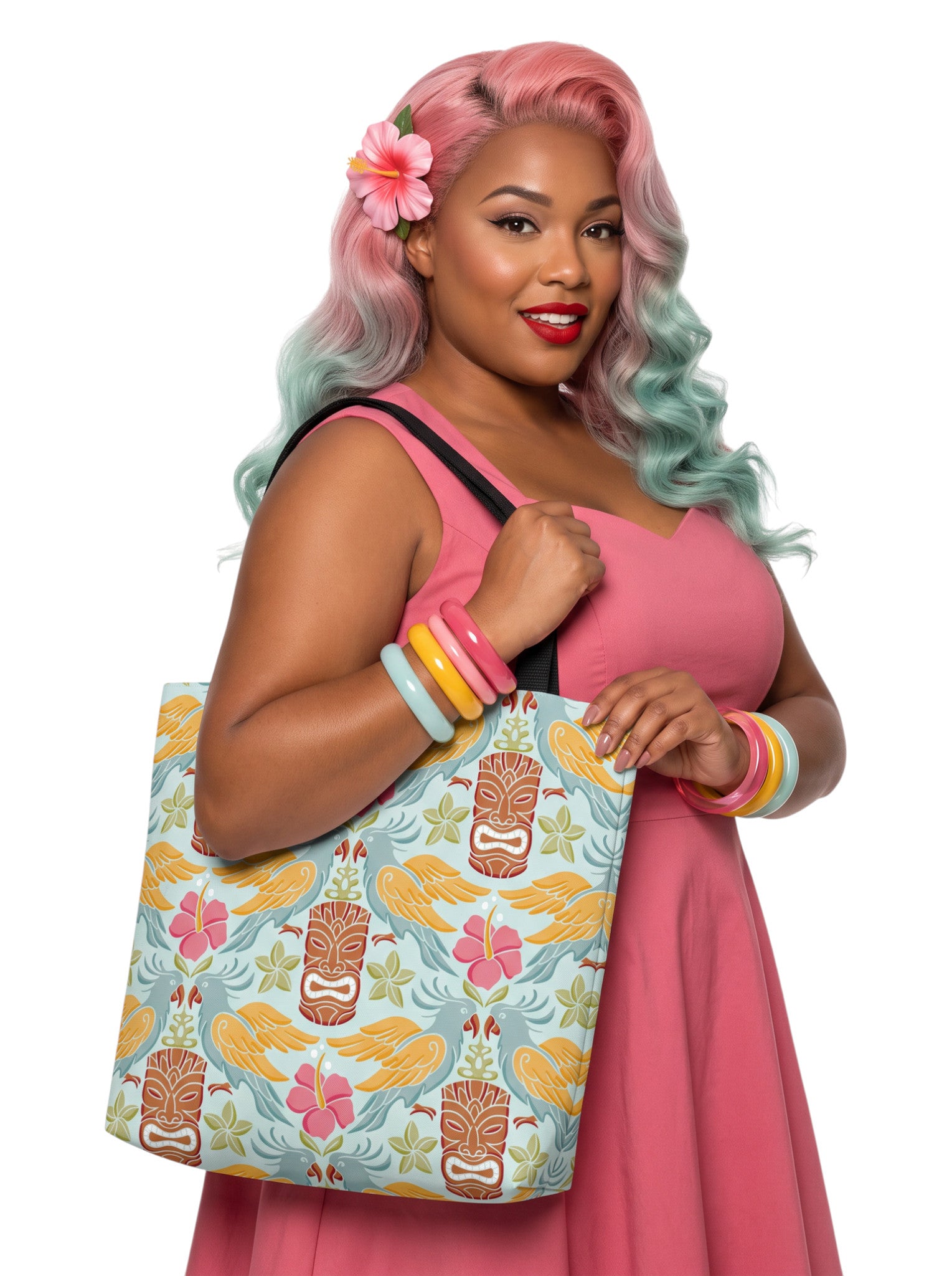 A woman holding a Tiki mask bird and hibiscus flower pattern tropical pinup tote bag with black handles.