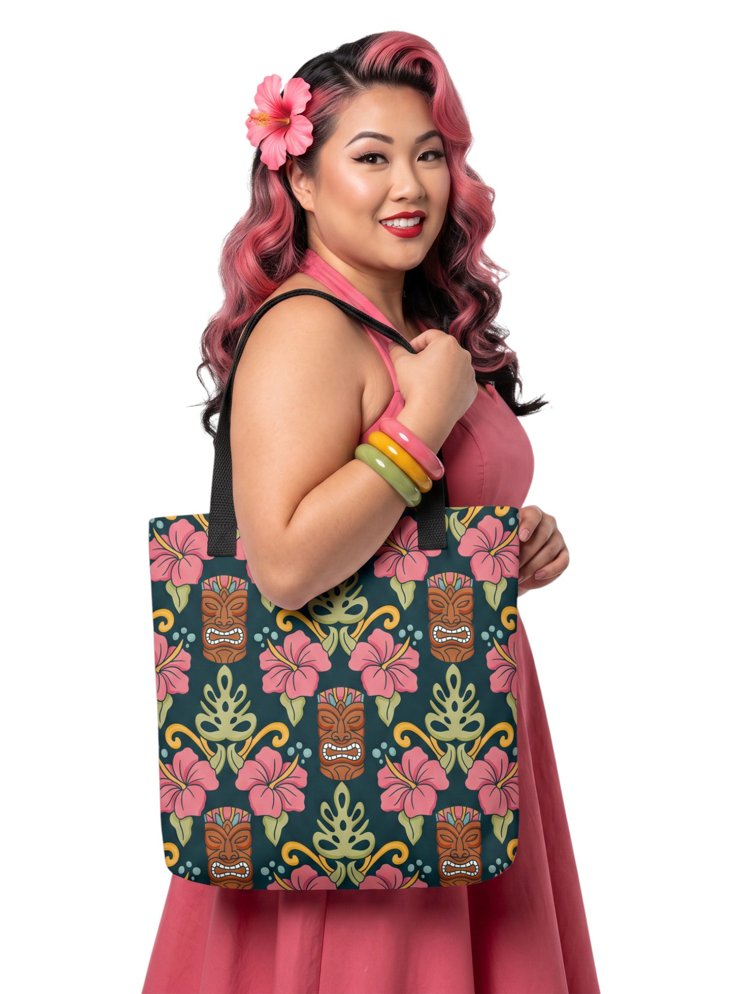 A woman holding a Tiki mask hibiscus flower pinup style tropical beach tote bag with black handles.