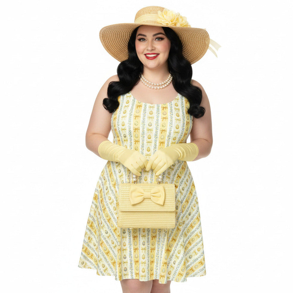 Plus size woman wearing a yellow 1950s vintage-inspired fit and flare dress with an Easter egg pattern, styled with a straw hat and pearls.