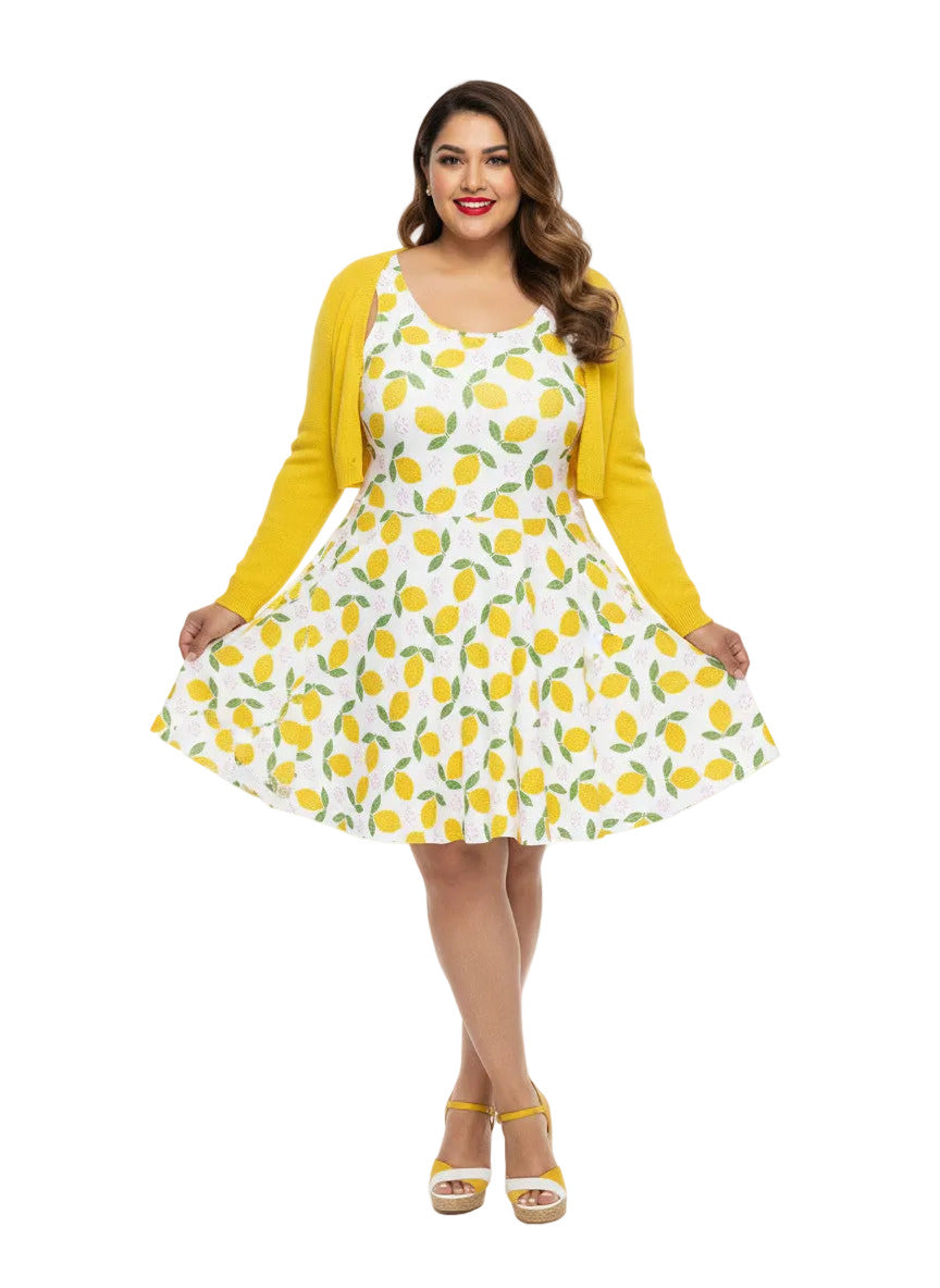 Plus size woman in a 1950s lemon print vintage swing dress with a fit and flare silhouette and yellow citrus pattern.
