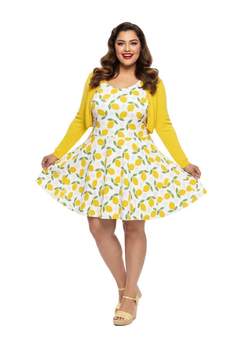 Plus size woman in a 1950s lemon print vintage swing dress with a fit and flare silhouette and yellow citrus pattern.
