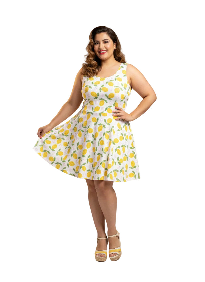 Plus size woman in a 1950s lemon print vintage swing dress with a fit and flare silhouette and yellow citrus pattern.