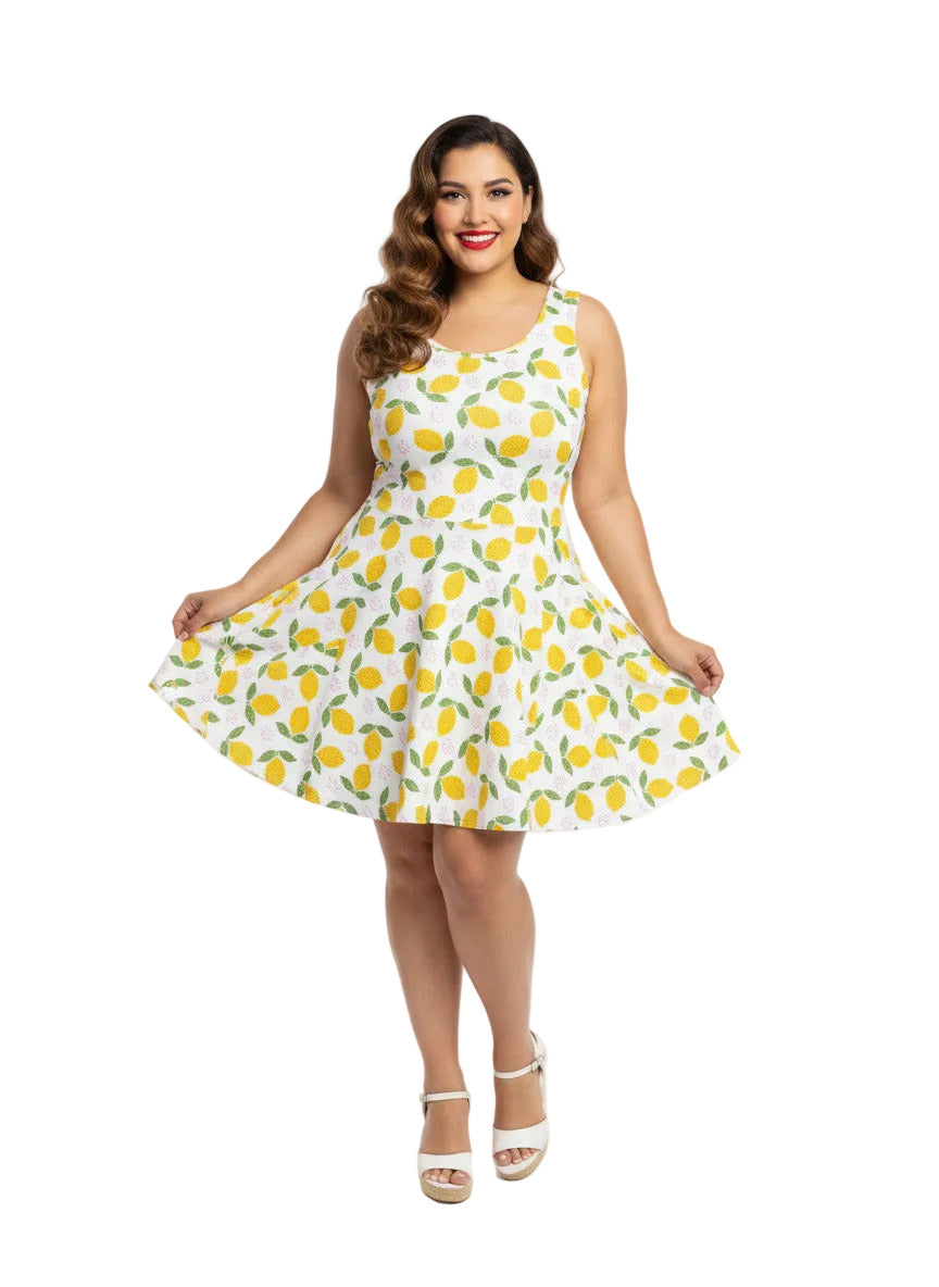Plus size woman in a 1950s lemon print vintage swing dress with a fit and flare silhouette and yellow citrus pattern.
