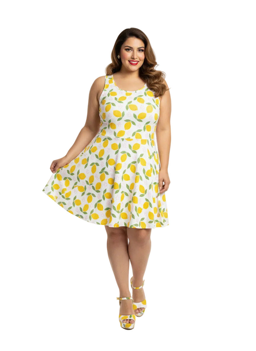 Plus size woman in a 1950s lemon print vintage swing dress with a fit and flare silhouette and yellow citrus pattern.