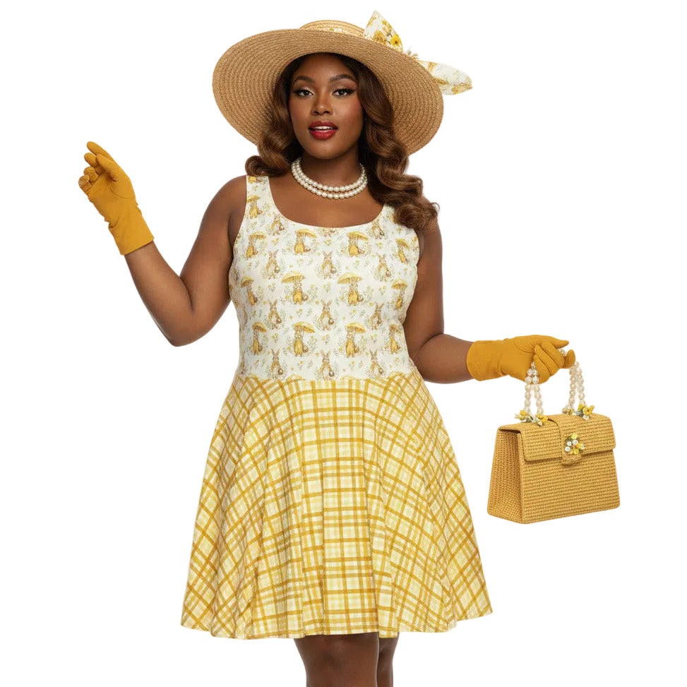 Plus size woman wearing a yellow gingham and Mr. Rabbit print 1950s vintage style fit and flare swing dress with straw hat.