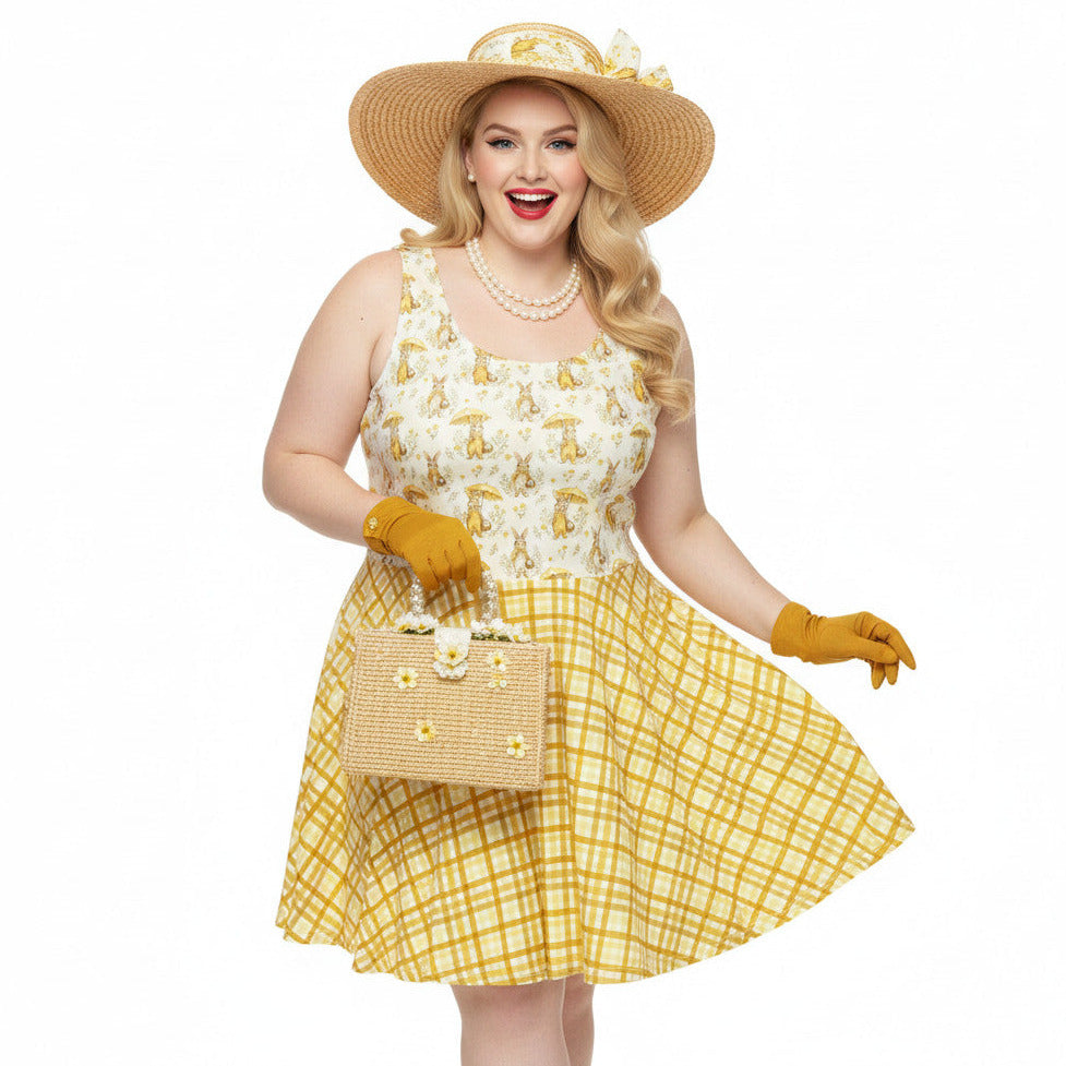 Plus size woman wearing a yellow gingham and Mr. Rabbit print 1950s vintage style fit and flare swing dress with straw hat.