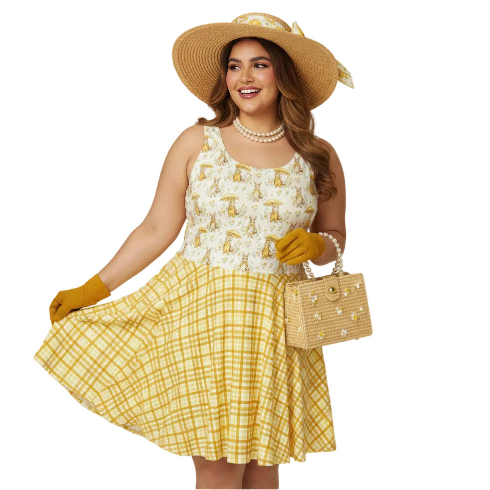 Plus size woman wearing a yellow gingham and Mr. Rabbit print 1950s vintage style fit and flare swing dress with straw hat.