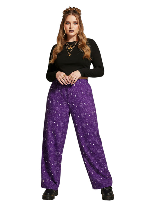 Woman wearing purple Whimsigoth wide leg lounge pants with celestial moon and sun print.